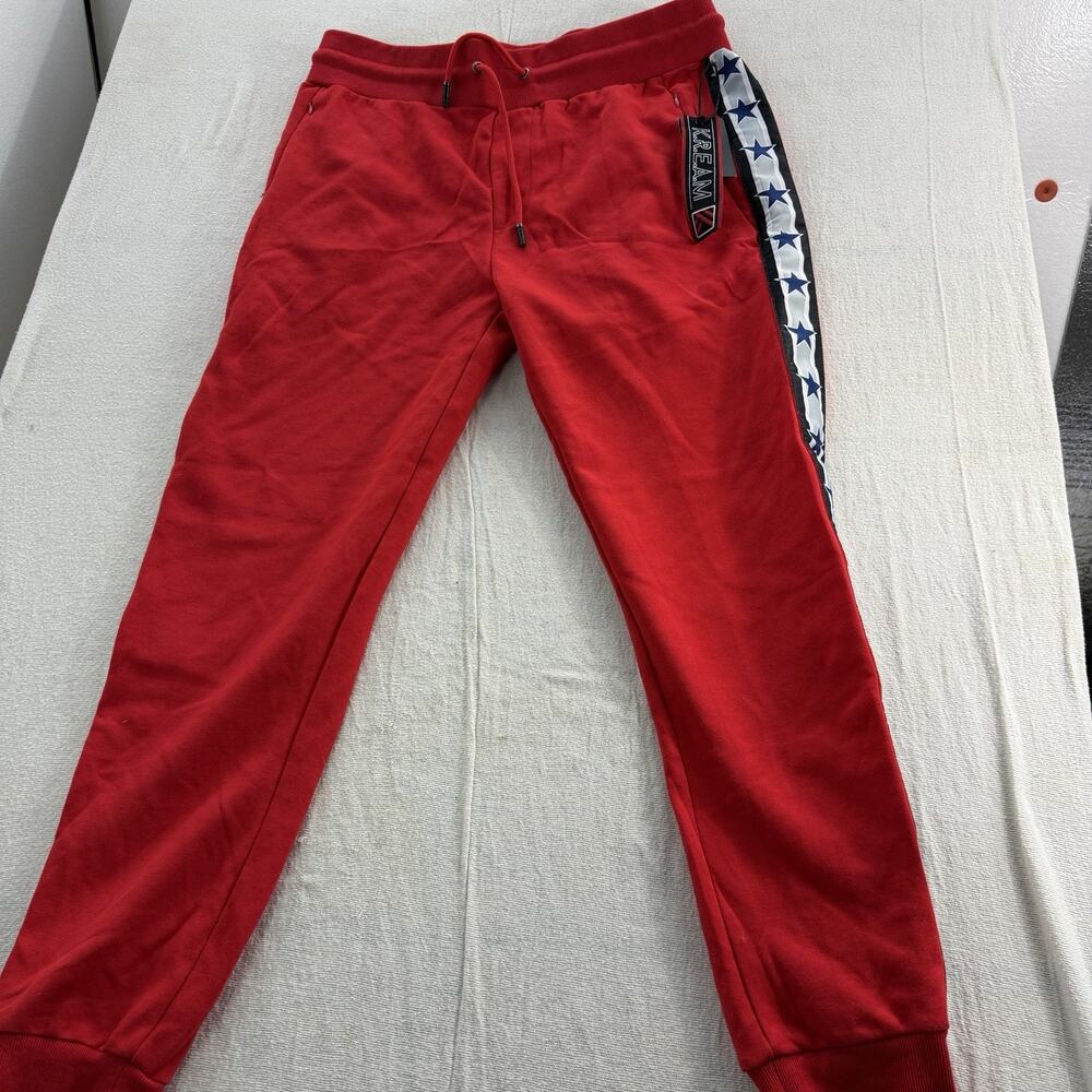 Kream red track pants featuring white taped side stripes with blue star NWT L